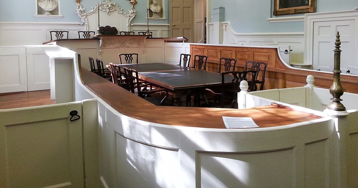 The interior of a historic wood-panelled courtroom