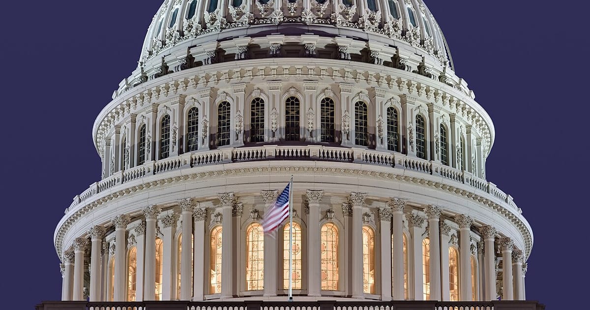 The illuminated dome of the United States Capitol at dusk