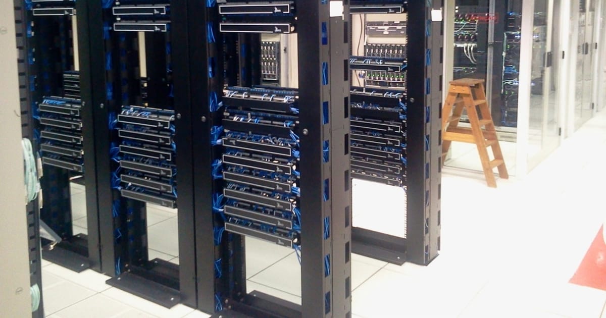Rows of network equipment racks in a server room